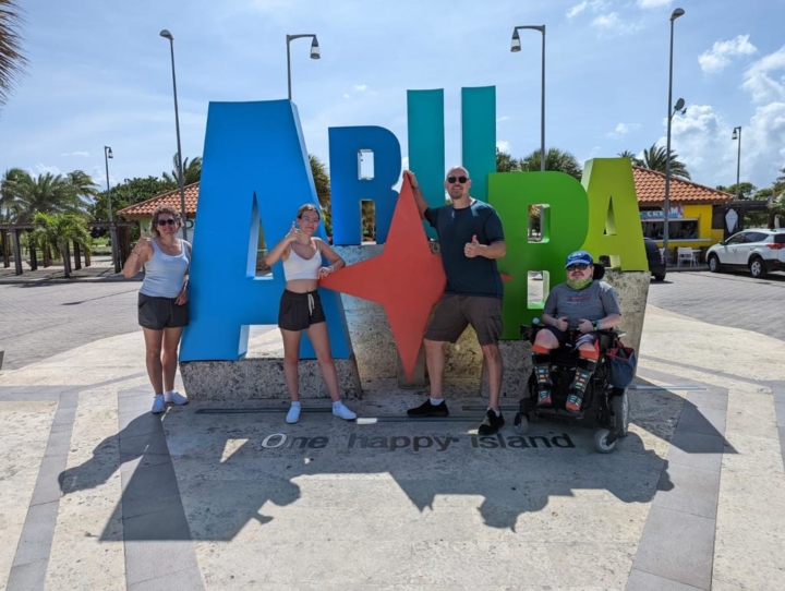 passengers-standing-aruba-sign